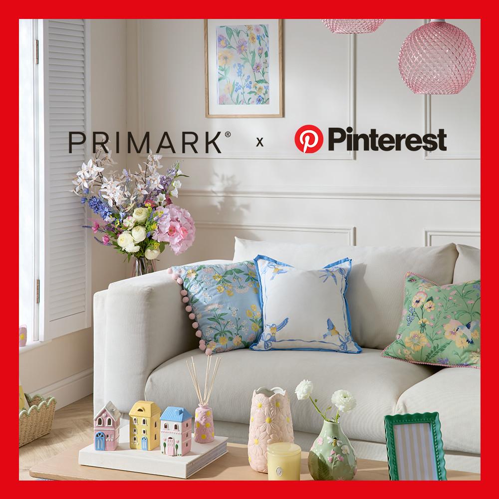 Primark x Pinterest living room with floral cushions, decorative vases, miniature house ornaments and fresh flower bouquet display.